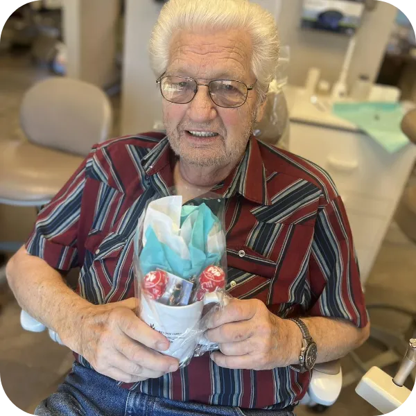 a happy dental patient receiving a gift